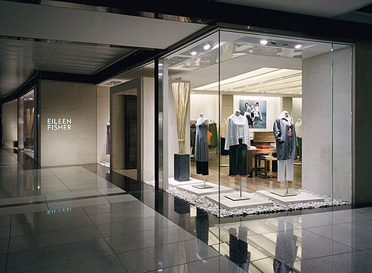 The minimalist aesthetic of Eileen Fisherâ€™s fashion line is echoed by the interior of her flagship store. Our task was to support this atmosphere with a tranquil ambience while providing the variety of light levels required for todayâ€™s retail environment.