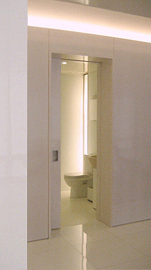 The bathrooms, with 8 ft. high ceilings, feel less confined thanks to their custom-made recessed vertical lights.